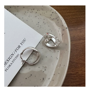 Detailed view of S925 sterling silver hollow twist earrings on a minimalist display card