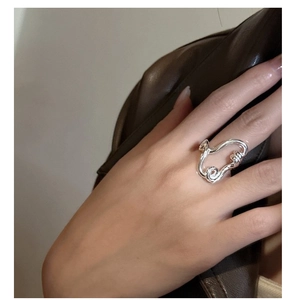 Close-up of minimalist S925 sterling silver twisted ring worn on index finger