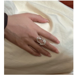 Close-up of twisted S925 sterling silver ring showing its minimalist organic knot design