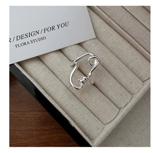 Detail of S925 sterling silver twisted ring displayed in a beige velvet jewelry box