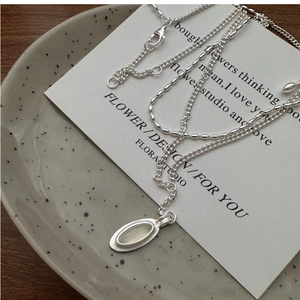 Detailed view of S925 silver double layer necklace with oval moonstone on vintage tray