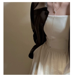 Minimalist S925 sterling silver Y-shaped long necklace styled over a stylish leather jacket