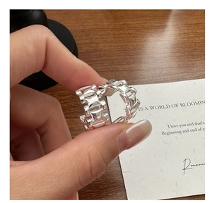 Vue macro d'une bague en argent S925 avec détails emblématiques de clous géométriques