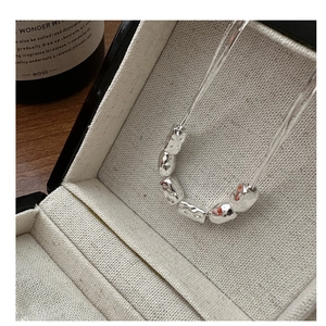 Detail of S925 sterling silver necklace with textured lava beads in a jewelry box
