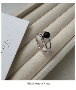 Close-up of S925 silver double-layer ring with a round black onyx stone on display