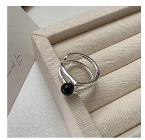 Detailed close-up of S925 sterling silver double-layered ring with black agate bead detail