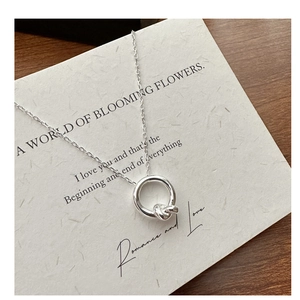 Detail of S925 sterling silver minimalist knotted pendant on a fine link chain