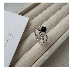 Macro detail of S925 sterling silver double-layer ring with black onyx bead inlay