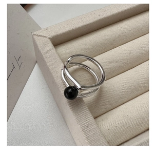 Macro detail of S925 sterling silver stamp on minimalist double-layer black onyx ring