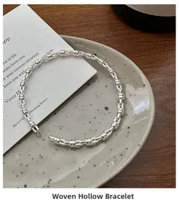 Detailed view of the braided hollow silver bracelet with intricate geometric structure