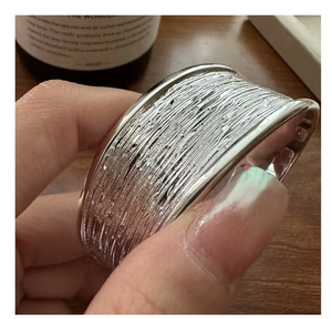 Macro shot of S925 sterling silver cuff bracelet featuring unique handcrafted lava texture