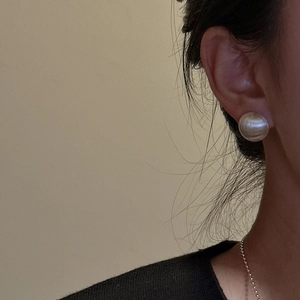 Minimalist S925 sterling silver brushed round stud earrings shown on model's ear