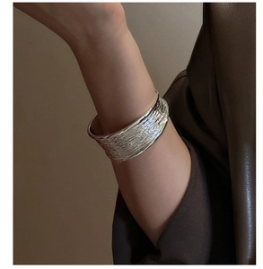 Close-up of S925 sterling silver cuff bracelet with unique layered textured finish