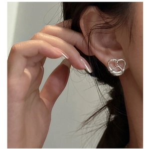Close-up of S925 sterling silver pretzel knot stud earring with mirror polished finish