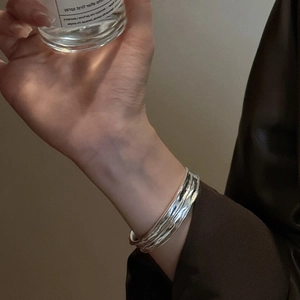 Minimalist S925 sterling silver open bangle with liquid-style irregular wave texture