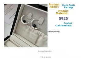 Detail of S925 sterling silver C-shaped earrings with black agate beads in a jewelry box