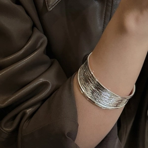 Textured S925 sterling silver wide open bangle featuring layered wire design on wrist