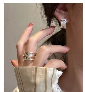 Detail showing matte S925 sterling silver ring and earrings with lava texture