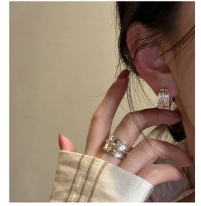 Close-up of S925 sterling silver earrings and ring set with irregular lava texture