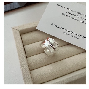 Detailed view of wide S925 sterling silver ring with irregular hammered texture finish