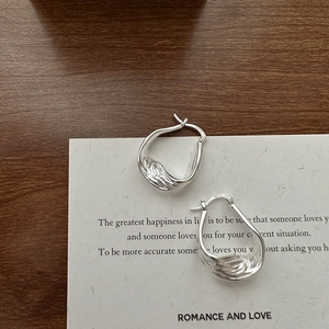 Textured S925 sterling silver hoop earrings with irregular lava design and drop shape