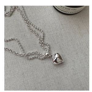 Detail view of 925 silver double-layered heart pendant necklace with ball chain