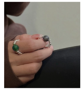 Close-up of S925 sterling silver beaded rings with green and labradorite gemstones