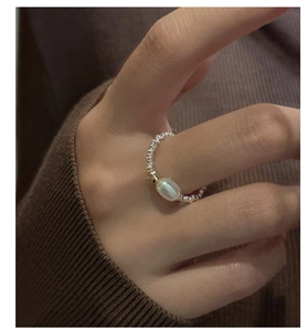 Dettaglio dell'anello in argento S925 a sfere con perla ovale indossato al dito