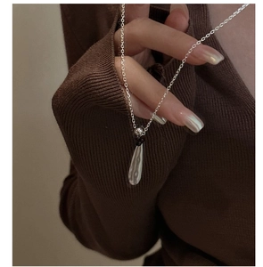 Detail of S925 sterling silver waterdrop necklace with black bead and mirror-polished finish