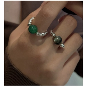 Detail of beaded S925 sterling silver rings with green aventurine and labradorite stones