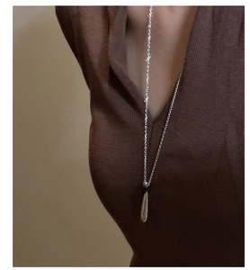 Minimalist S925 sterling silver water drop pendant necklace shown on a brown sweater