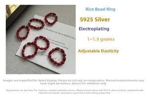 Detail of red rice bead ring with S925 silver accents and adjustable elastic cord