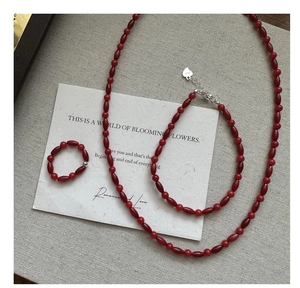 Detailed view of red bead jewelry set with S925 sterling silver heart charms and clasp