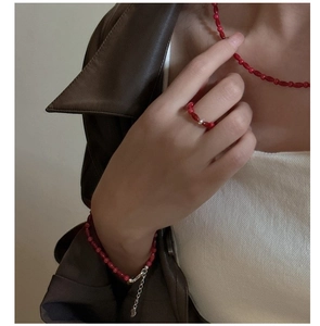 Detail view of S925 silver red beaded jewelry set with heart pendant on model