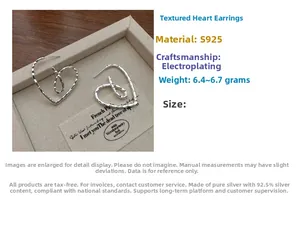 Detailed macro view of S925 sterling silver textured heart earrings with hammered finish