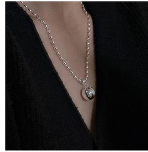 Close-up of polished S925 silver bead chain necklace with a mirror-finish sphere pendant