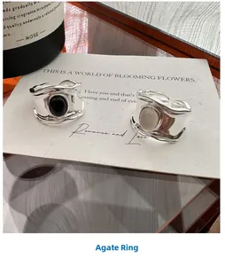 Detail of S925 sterling silver ring with black oval agate and irregular wavy band