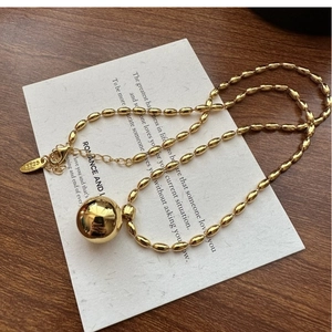 Detailed close-up of S925 sterling silver gold ball pendant necklace with oval beads