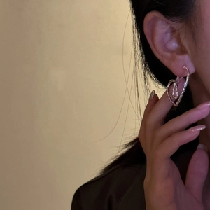 S925 sterling silver double heart earrings with trendy lava texture on female model