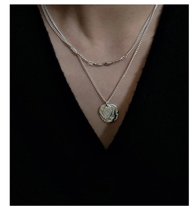 Close-up of S925 sterling silver double-layered necklace with hammered round pendant