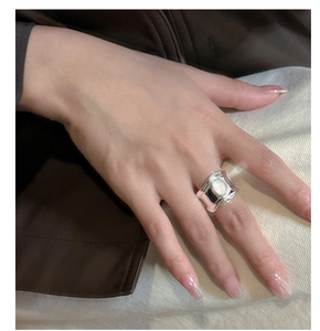 Detail view of a S925 sterling silver ring with oval gemstone on a hand model