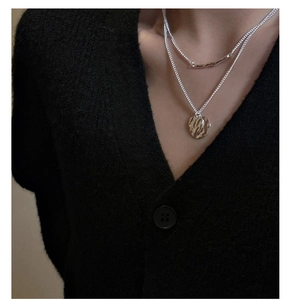 Close-up of double layer S925 silver necklace featuring hammered circular pendants on a model