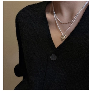 Detail of S925 sterling silver double-layer necklace with textured round coin pendant