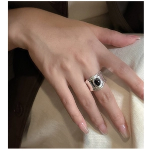 Close-up of S925 silver ring with oval black onyx gemstone and hammered metal texture
