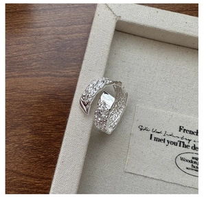 Macro shot of S925 sterling silver ring with irregular hammered texture and artistic finish