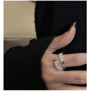 Detailed view of S925 sterling silver ring with textured crinkle finish on finger