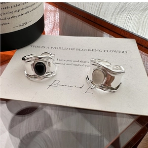 Close-up of S925 silver wide open rings with oval black agate and white gemstone