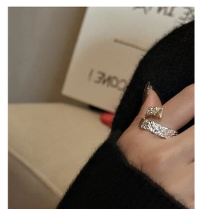 Macro detail of S925 sterling silver ring with irregular hammered texture on female finger