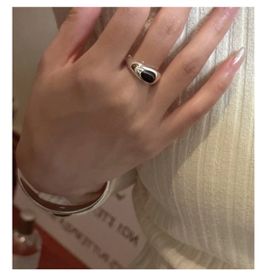 Detail of vintage S925 sterling silver ring with oval black agate gemstone on hand