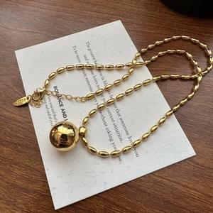Minimalist S925 sterling silver beaded necklace featuring a large golden ball pendant